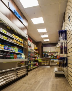 New retail shelving using slatwall paneling, with wood effect laminated fascia panels above