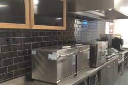 Bespoke backbar with stainless steel worktop and black metro tiled backbar wall
