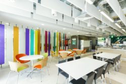 Glass panels fixed in to rotatable floor fixings finsihed in customer logo realted vinyl colours