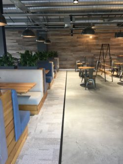 Flooring finished in polished conrete with transition strip to Interface carpet tiles
